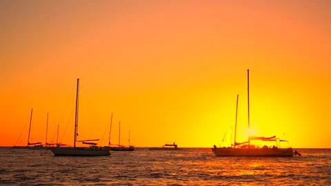 Sun rays through the mast of tourist yacht. Sunset in the port.  Stock Footage 197674585
