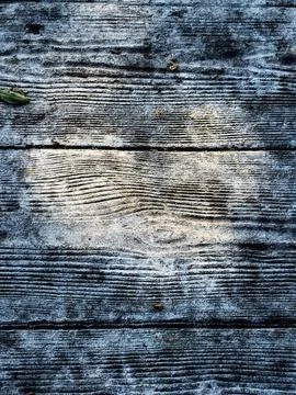 Sun rays through tree branch shadows form a heart on wood. Stock Photos
