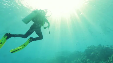 Sun rays through water diver swims up 02 Stock-Footage 36754960