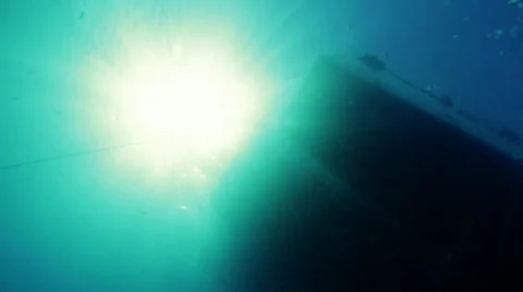 Sun rays through water diver swims up Video stock 36756080