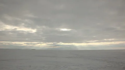 Sun rays throught clouds on the snowfield timelapse Видео 1806968