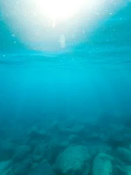 Sun rays in the water column. Stock Photos