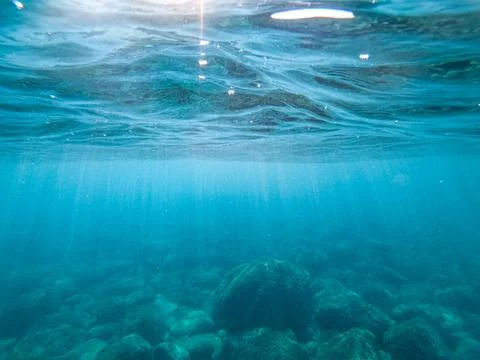 Sun rays in the water column. Stock Photos