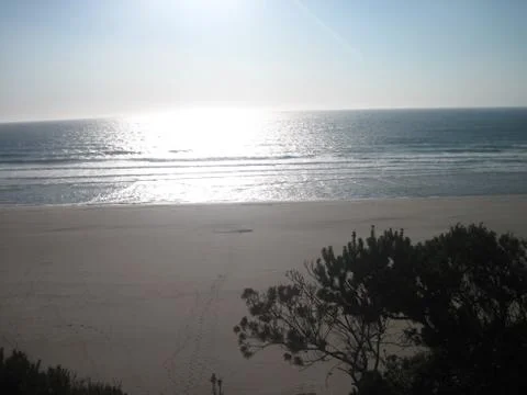 Sun ready to set on beach Stock Photos