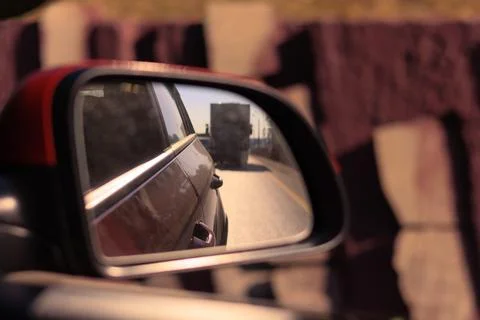 The sun is reflected in the mirror, evening road. Stock Photos