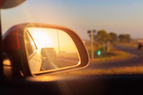 The sun is reflected in the mirror, evening road. Stock-Fotos