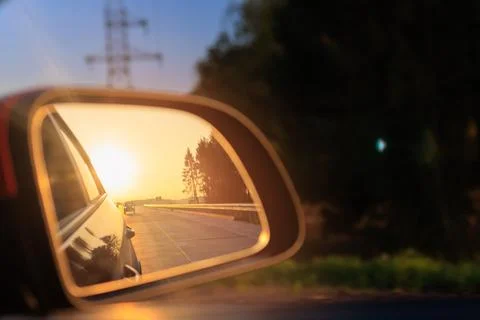 The sun is reflected in the mirror, evening road. 스톡 사진