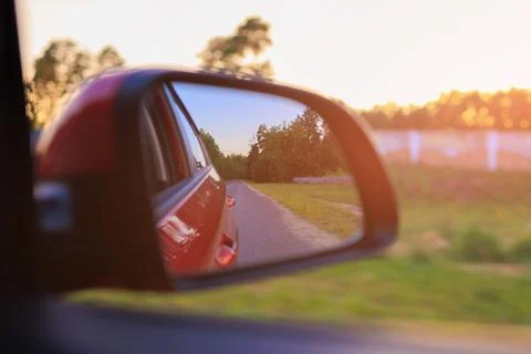 The sun is reflected in the mirror, evening road. Photos