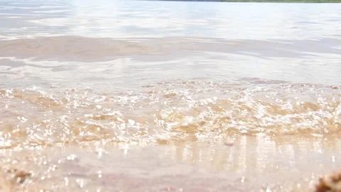 The sun reflected in a sparkling blue lake, pond at sunset, sunrise. Stock Footage 204970380