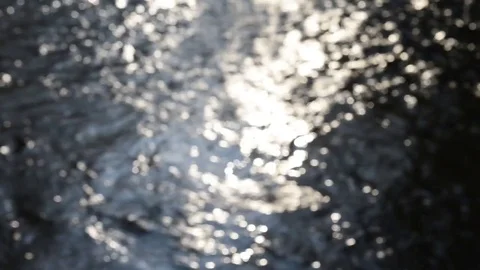The sun is reflected on the water of the torrent pushed by the strong current Stock Footage 83912565