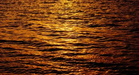The sun is reflected in the waves of the sea, liquid gold Stock Photos