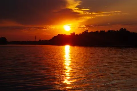 The sun is reflected on the waves, warm summer evening, romantic landscape Stock Photos