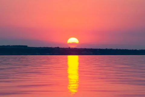 The sun is reflected on the waves, warm summer evening, romantic landscape Stock Photos