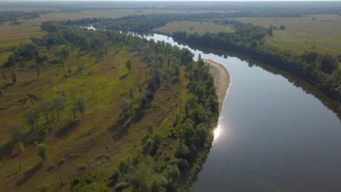 The sun is reflected in a winding beautiful river. Aerial view. Stock Footage 117415585