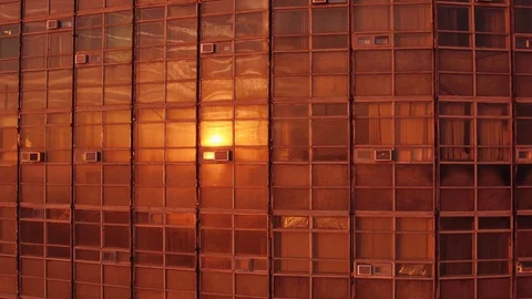 Sun reflected in the windows, office building at dawn, aerial view. Video stock 129965523