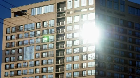 The sun is reflected in the windows of a residential building Stock Footage 165229174