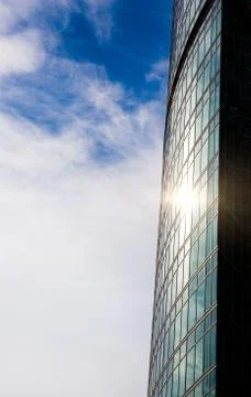 The sun is reflected in the windows of a tall office building. Business concept Stock Photos