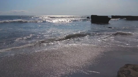 Sun Reflecting On Frothy Waves On gray Sand Beach Stock Footage 82806612