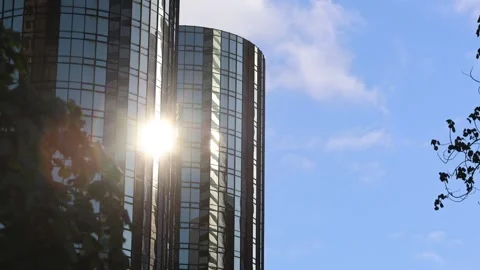 Sun Reflecting Off Mirrored Building With Blue Sky Stock Footage 337679557