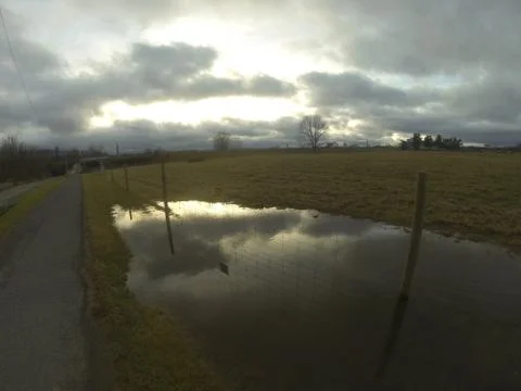 Sun reflecting off puddle Stock Photos