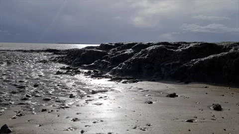 Sun reflecting on the sand in the winter by the coastline 動画素材 144322423