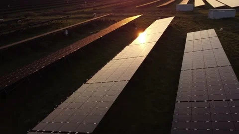 Sun reflecting on solar panel farm during aerial inspection at sunset. Stock Footage 163163490