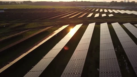Sun reflecting on solar panel farm during aerial inspection at sunset. Stock Footage 163163713