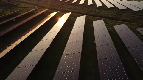 Sun reflecting on solar panel farm during aerial inspection at sunset. Stock Footage 163163834