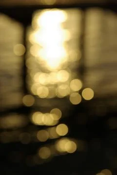 Sun reflection blurred glowing light particles of shades of white and yellow Stock Photos