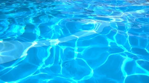 Sun reflection in clear and bright blue water of resort swimming pool Stock Footage 88538218