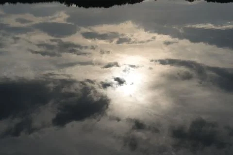 Sun Reflection on Cloudy Sky over Lake Port d’Albret Stock Photos