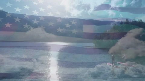 Sun reflection drawing pair paddling for leisure near mist, flag overlay Stock Footage 333657260