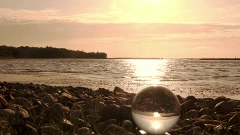 Sun reflection in glass ball on the water Stock Footage 252175483