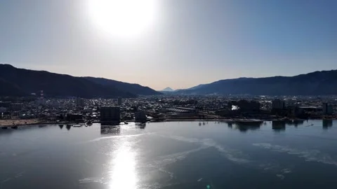 Sun Reflection Lake Suwa│Silhouette Mt Fuji│Winter Aerial│4K Stock-Footage 329063357