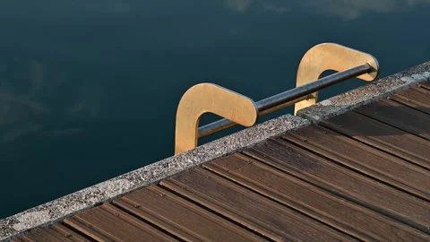 Sun reflection on a metal dock ladder at a sea pier Stock Footage 317338677
