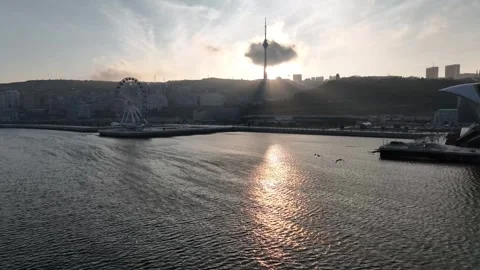 Sun Reflection on Water with City Skyline and Tower at Sunset Stock Footage 341893333
