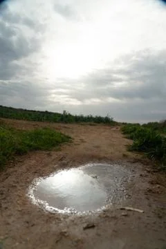Sun reflection in water puddle Stock Photos