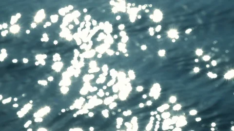 Sun reflection on wavy water with beautiful bokeh of sun glares like stars 動画素材 120023023