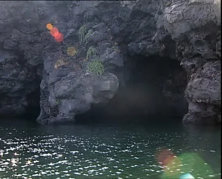 SUN REFLECTIONS and sea cave Stock Footage 12712884