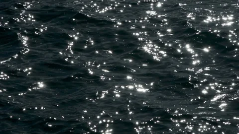 Sun reflections sparkle on water blinking in back light. Norwegian fjord beauty Stock Footage