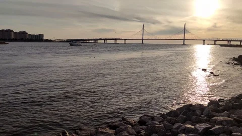The sun reflects off the waves of the bay on the city landscape Stock Footage