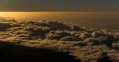 The sun rises above the clouds, creating a breathtaking scene of natural beau Stock Photos