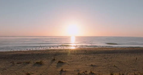 Sun rises above ocean, marking the start of a new day Stock Footage 303314484