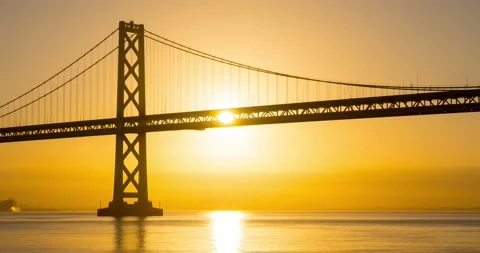 Sun Rises Behind The Bay Bridge in San Francisco Stockbeeldmateriaal 236573109