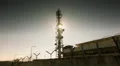 Sun rises behind big communication tower in energy facility barbed wire HD Footage