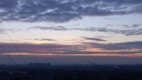 The sun rises behind the clouds in an industrial city Stock Footage 124770606