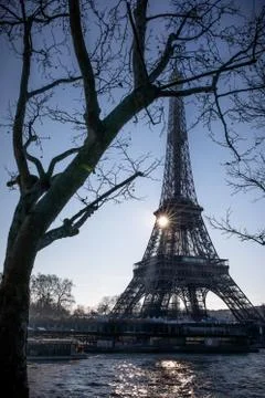 The sun rises behind the Eiffel Tower on the Seine River, Paris 스톡 사진