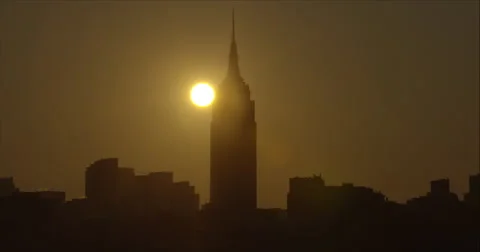 The sun rises behind the Empire State Building early morning Stock Footage 67275028