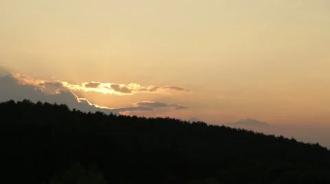 The sun rises from behind the forest Stock Footage 44019128