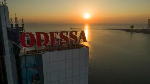 Sun rises behind large Odessa Sign Ukraine Stock Photos